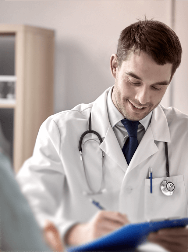 Smiling male doctor writing on a clipboard, representing professional medical support and patient care